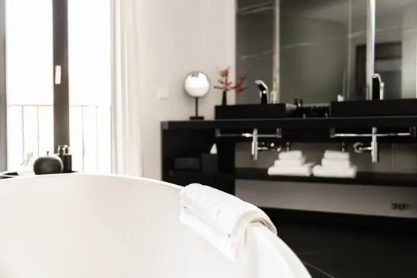 Ein weißes Handtuch auf einer Badewanne im Badezimmer.