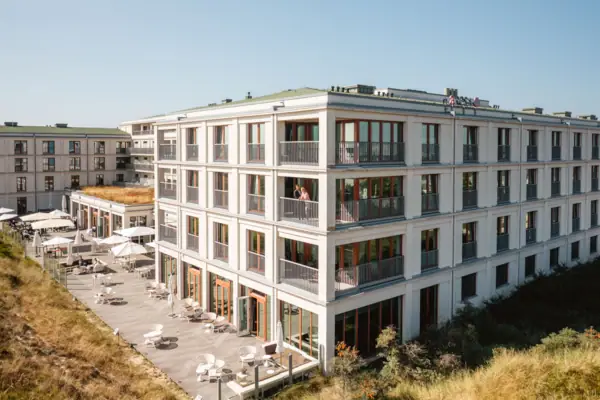 Ein Gebäude mit vielen Fenstern und einer Terrasse.